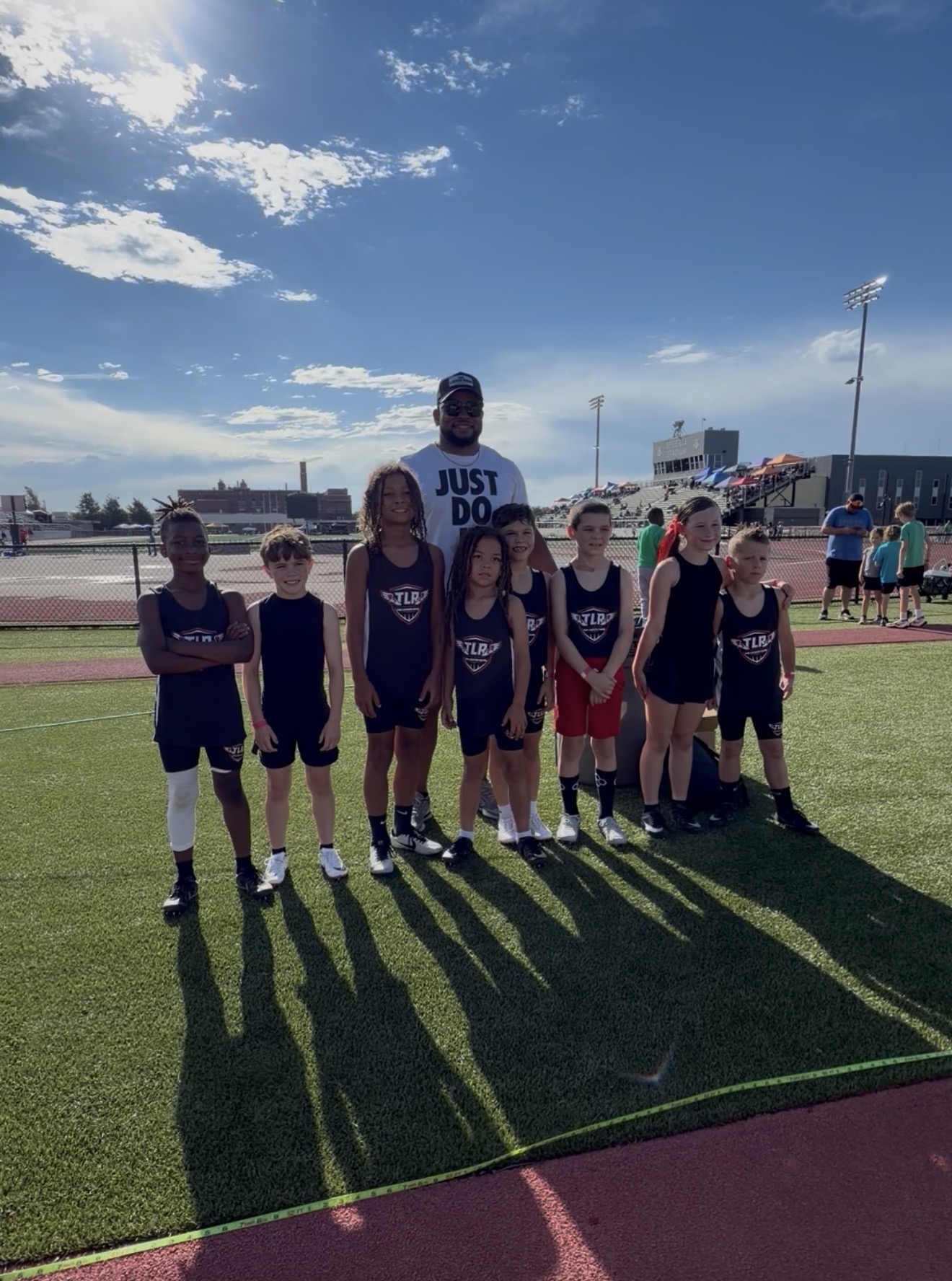 The Locker Room track team together at a meet
